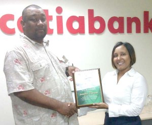 Scotiabank’s Jennifer Cipriani receives the award from RHTY&SC’s Hilbert Foster.