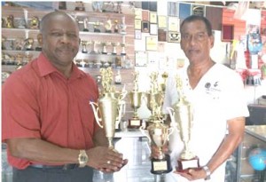 Ramesh Sunich, of Trophy Stall hand over trophies to Donald Sinclair of Flex Night Inc.