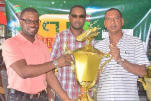 UDFA President Sharma Solomon (left) receives the first place trophy from Ramesh Sunich of Trophy Stall, while Jeoff Clement (centre) GT Beer Brand manager looks on.