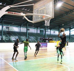 Tutorial High School’s Zion Gray splits his defence to go up for an easy basket Saturday at the Cliff Anderson Sports Hall in YBG Age-Group Tournament.