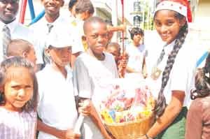 A child of Joshua House receiving a donation from a Bishops’ High School student 