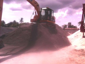 An excavator operates atop a pile of bitumen made at the plant.