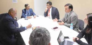  Guyana’s Minister of Governance Raphael Trotman (at left) in discussion at the United Nations Framework Convention on Climate Change Conference in France 