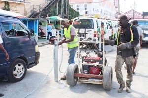 City employees working on the bus park lanes.