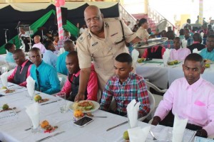 Commissioner (Ag) Mr. Balram Persaud serves lunch.