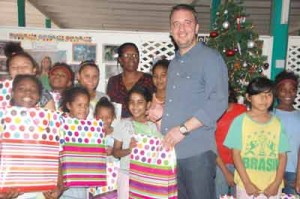 Ramada’s General Manager and Sales and Marketing Director (Back Row) pose with the girls and their gifts.