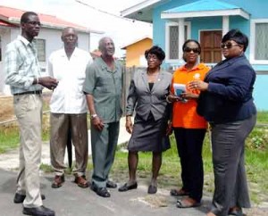 Minister Keith Scott (third from left) with other officials  at the Recht-Door-Zee housing development