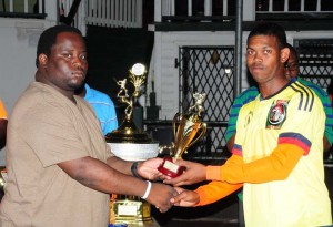 Man of the match Steve Mohamed (right) collects his trophy from Adeel Lilly.