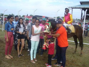 Time to celebrate as connections of the Bacchus stable receives their prize for Strom Bird convincing victory in the E and lower race.