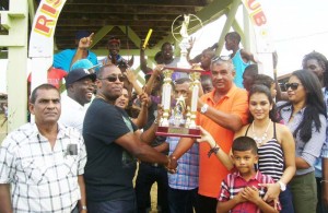 Banks DIH Manager Mortimer Stewart presents the winning Banks DIH trophy to Connections of The Jagdeo stable for Just Call Me Boss  victory in the feature event.