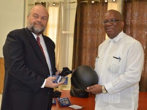 Minister of Finance Winston Jordan receives some of the equipment from the US Ambassador Perry Holloway.