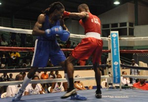 Guyana’s Dennis Thomas (right) lines up St Lucian Arthur Langelier for a thunderous right in their Middleweight bout (Sean Devers photo)