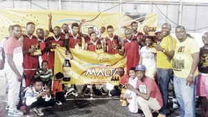 Banks DIH Non-Alcoholic Brand Manager, Clayton McKenzie (standing second, right) and Linden Manager, Shondel Easton (on his right) along with LABA President, Lawrence Simon (left) join the Bulls’ celebration Saturday night in Linden.