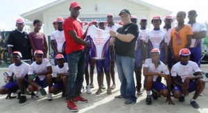 Owner of Benjamin’s Sports, former national cyclist and overseas based, Wilbet Benjamin handing the new uniforms to Patron of the FACC, Errol Alphonso.