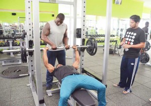 Ronnie Sarwan watches as a pair of body builders go through their paces at the Providence based facility.