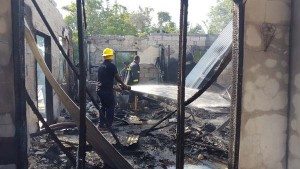 Fire fighters at work in the destroyed building.