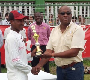 Joshua Persaud receiving his MOM trophy from Clive Pellew, brand manager of Rainforest Water.