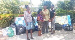 One of the three fire victims yesterday talking with GRC’s Administrative Officer Lynette Carter (second from right) 