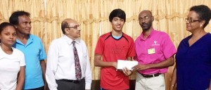  Garfield Wiltshire, Treasurer of the GOA, presenting the cheque to Narayan Ramdhani in the presence of GOA President Mr. Kalam Jumin-Yassin (3rd left), GOA’s Karen Pilgrim (right) and Taekwondo Association President  Ramjeet Ramphal and Secretary.