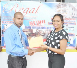 Abel Seetaram (left) of WBCA accepts the cheque from Telesha Ousman Yamin. 