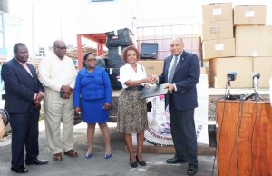 Minister Raphael Trotman receives the mining school support from Ms Khadija Musa