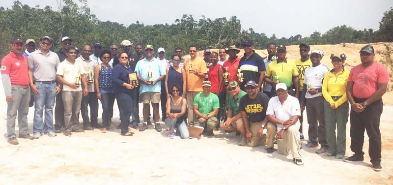 Competitors, including prize winners at the inaugural Evrall Franklin Memorial Hand Gun Shoot pose with their silverware following the presentation on Sunday at the GDF Timehri Range.