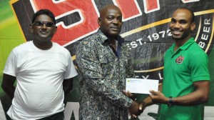 STAG Brand Coordinator Mr. Lindon Henry (right) hands over the cheque to EBFA President Franklin Wilson in the presence of Executive Member, Seenauth Ransahai.