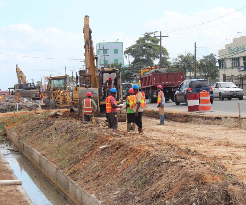 Some construction workers assembled opposite the Ming’s Services Ltd. yesterday afternoon. 