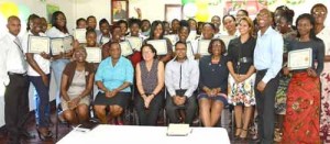 We did it! The women beam with pride as they display their certificates after the graduation ceremony. First Lady, Mrs. Sandra Granger is pictured seated, centre 