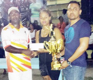 Winning skipper (left) collects his cash and trophy from Ray Ali of Asheik and Son Motor Supplies and Auto Sale in the presence of Carib Beer rep.