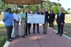 Erik Oswald, Vice President, Americas, ExxonMobil Exploration Company symbolically presents the $20M cheque to Minister of Natural Resources Raphael Trotman and Commissioner of Protected Areas Commission, Damian Fernandes. Also in photo are other ExxonMobil officials and natural resources stakeholders.