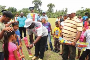 Commander Stephen Mansell hands over a kite to an excited Bonasika youth.      