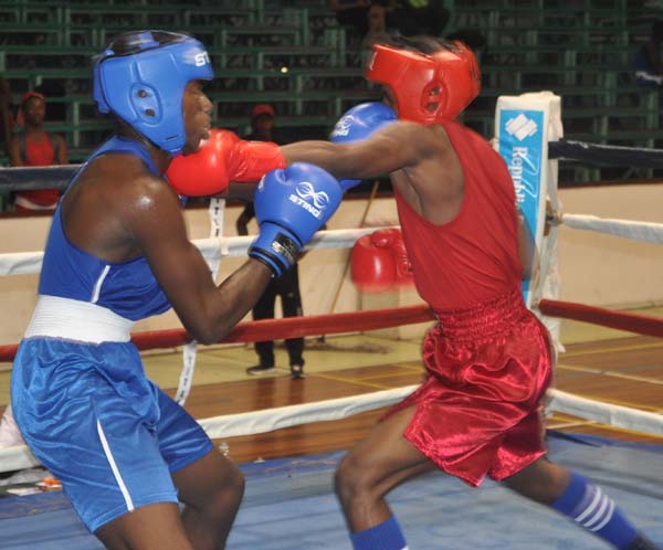 Michael Edwards (left) delivers a stiff left jab to Joshua Forest Davidson’s head during their bout at the Sport Hall Friday.