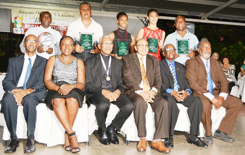 President David Granger, (third, left), Minister Nicolette Henry (second, left) and GOA President K. A. Juman Yassin (fourth, left) join other GOA Executives and recipients of Awards for a photo moment Friday night at Georgetown Club.