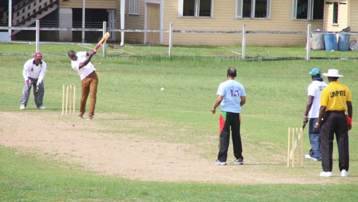 Former Guyana All-Rounder, Lennox Cush, playing for Boyce/Jefford Select XI, attempts a big shot against Trophy Stall’s Ramesh Sunich on Sunday in the softball match at the Police Sports Club Ground, Eve Leary.