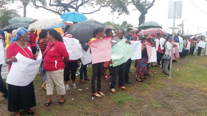 PPP supporters protest outside of the Ministry of the Presidency yesterday.