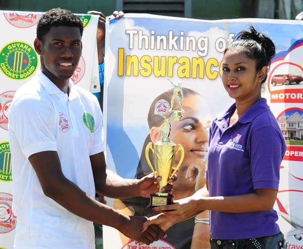 Keemo Paul accepts his man-of-the-match prize from Hand-in-Hand Marketing Representative Chandranie Karran. 