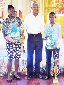  President Granger with Shemaine Campbell (right) and Tremayne Smartt after presenting them with their trophies and hampers. 