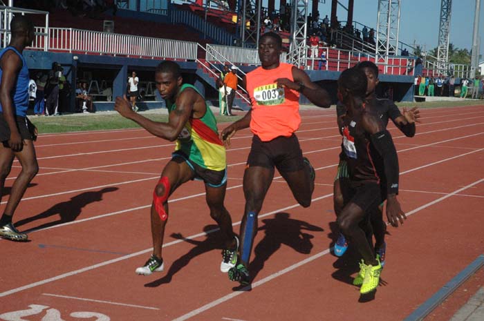 Flashback! GDF’s Davin Fraser (second, left) hands over to team-mate, Wayne Harlequin while Police’s Tevin Garraway gives way to Winston George in the 4x400m last year at Joint Services.