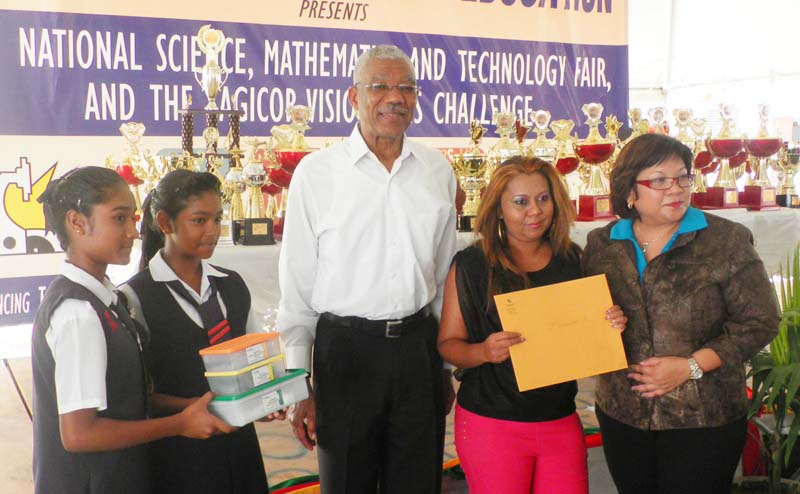 Winners from Uitvlugt Secondary pose with the President Granger after receiving their first prize in the lower division for their project - making tableware from bagasse.