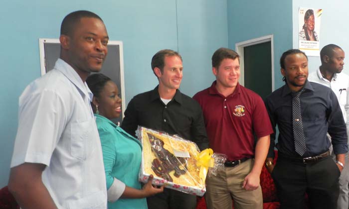 Linden Mayor Carwyn Holland (left) appears pleased as his deputy presents Humanitarian Assistance Programme Director Eric Antinucci with a gift.