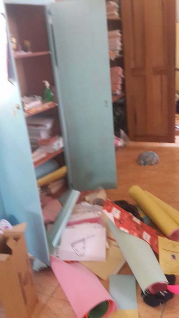  The tumbled cupboards and strewn teaching materials.