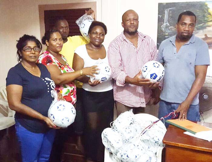 (From right) Mr. Sherwin Forde (Berbice Football Association VP) presents the footballs to several club reps.