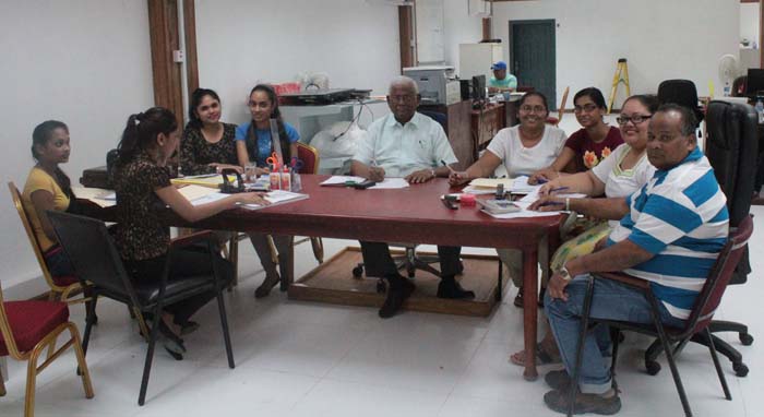 Sattaur Gafoor (centre) with some of his staff yesterday. 