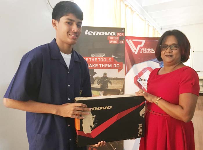 Ms. Bibi Narine Executive Assistant of Visnu Panday & associates Inc. makes the Presentation to Narayan Ramdhani. 