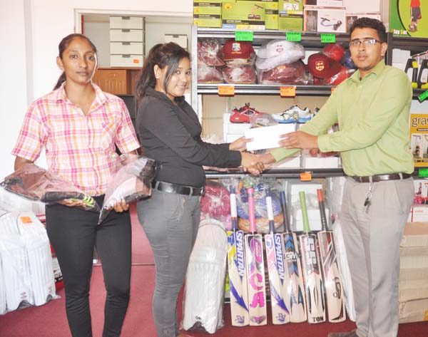 Sherryann Persaud (left) presents the cheque to GSCL Inc Assistant Secretary/Treasurer Russel Jadbeer in the presence of Sunita Charan of Regal Sport. 