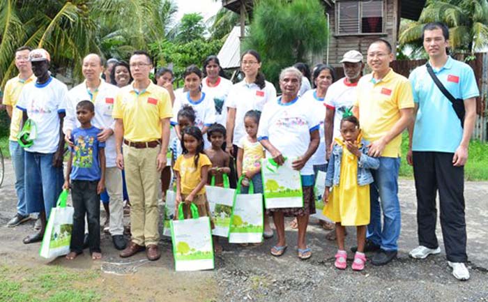 Members of the Chinese Medical Brigade distributing clothing and other items to the residents of Angoy’s Avenue, Berbice.