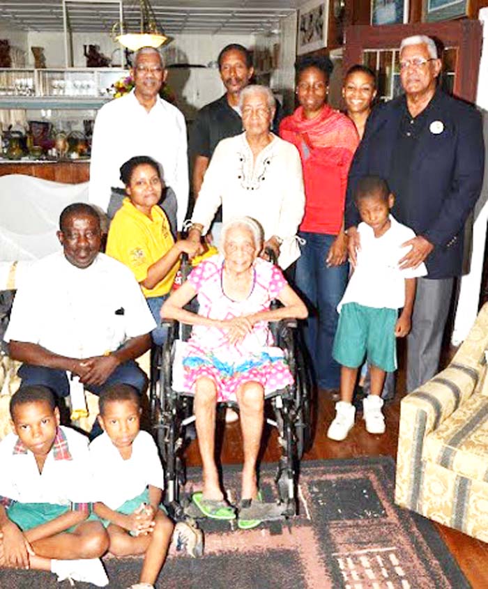 President David Granger (left, back row) celebrates with Ms. Ina Holder and her relatives.  Minister of Agriculture, Mr. Noel Holder is at right.