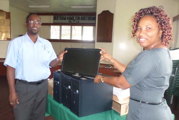 GTU President Mr. Mark Lyte (left) helps to display the donated computer systems.