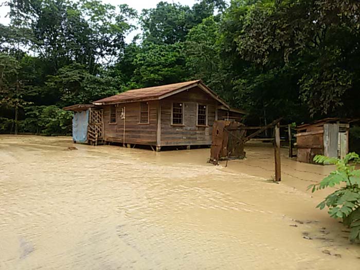 A resident’s house completely surrounded by flood waters.